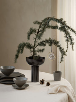 Blomus Vase Miyabi in schwarz weihnachtlich dekoriert auf einem Tisch mit Kiefernzweig.